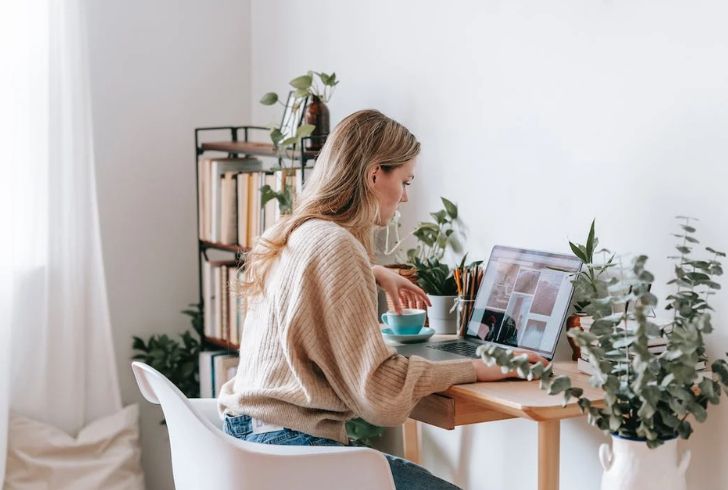 Flexible Work Setup: Laptop, Coffee, and Ocean View